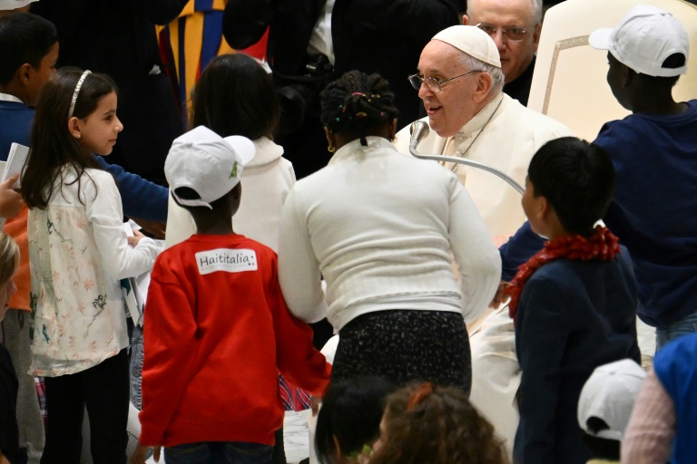 Pope Francis meeting children at the Vatican on Monday (Alberto PIZZOLI)