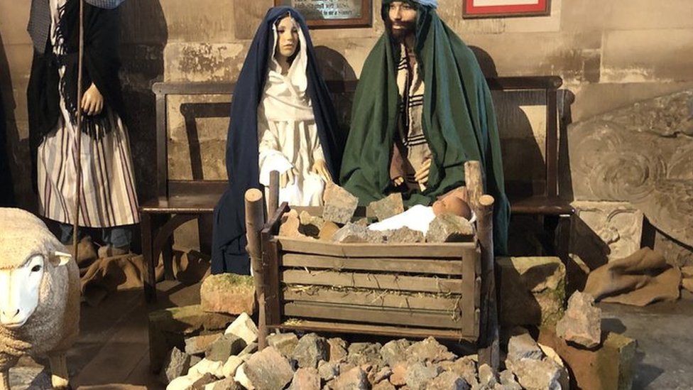 Tewkesbury Abbey's rubble nativity scene highlights children affected by war