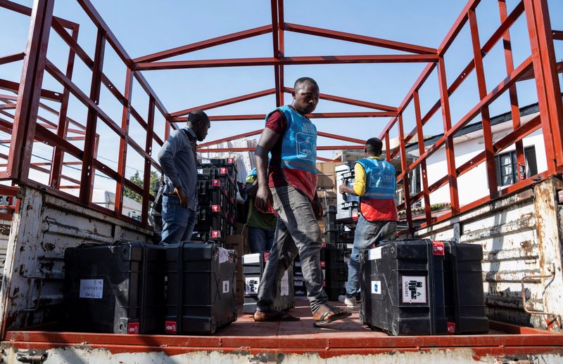CENI agents load electoral kits onto trucks for deployment to the polling locations ahead of the Presidential election in Goma